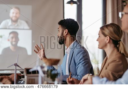 Young Colleagues Having Meeting, Consulting About Green Energy.