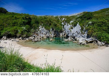 Playa De Gulpiyuri, Flooded Sinkhole With Inland Beach Near Llanes, In Asturias Northern Spain, Arou