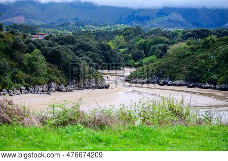 View On Playa De Poo During Low Tide Near Llanes, Green Coast Of Asturias, North Spain With Sandy Be