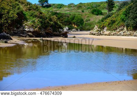 View On Playa De Poo During Low Tide Near Llanes, Green Coast Of Asturias, North Spain With Sandy Be
