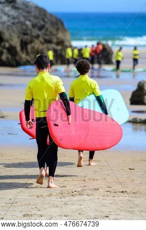 Young Surfers Train On Playa De Palombina Las Camaras In Celorio, Green Coast Of Asturias, North Spa