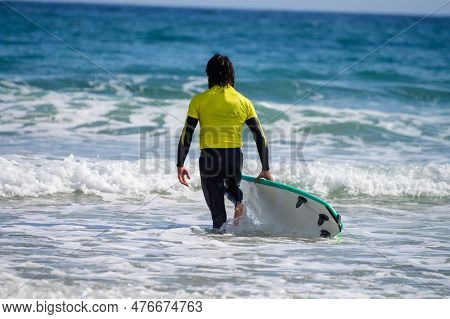Young Surfers Train On Playa De Palombina Las Camaras In Celorio, Green Coast Of Asturias, North Spa