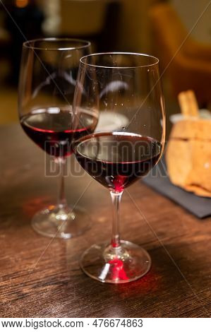 Dinner With Glass Of Dry Red Wine In Italian Osteria Restaurant