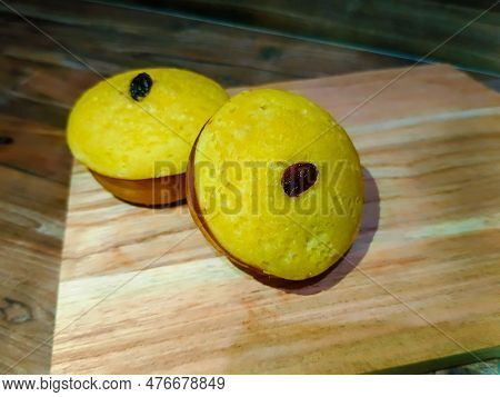 A Mud Cake With Raisin Topping Against A Background Of Wood Texture, Mud Cake With Raisin Topping On