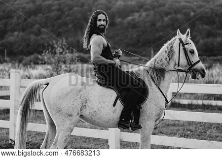 Hunky Cowboy. Young Muscular Guy In T-shirt On Horseback. Man Riding A Horse. Hunky Cowboy Rides Hor