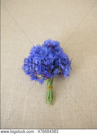 A Small Flower Bouquet With Cornflowers On Light Farbric