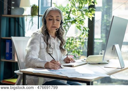Good-looking Mature Business Woman At The Computrer Looking Busy