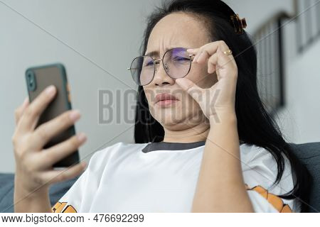 Asian Senior Fatigue Woman Try To Move Eye Glasses During Using Smartphone After Surfing Internet Or