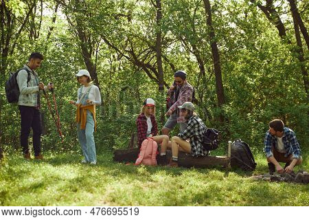 Grouof Of Young People, Friends Goig Hiking, Walking In Forest, Sitting On Meadow, Having Picnic On 