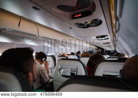 Germany - Jul 6, 2015: A Group Of People Enjoy The View Inside An Airplane Cabin While Traveling In 