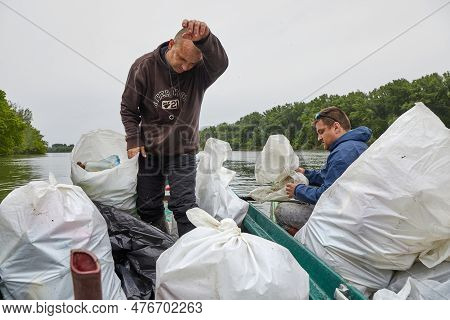 Tiszafured, Hungary - Circa 2023: Volunteers Collecting Plastic Waste From The River Tisza Using Can
