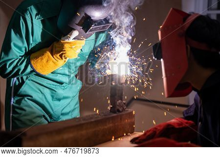 Metal Welding Steel Works Using Electric Arc Welding Machine To Weld Steel At Factory. Metalwork Man