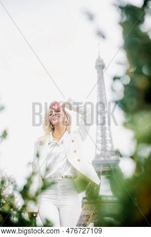 Young Lady In White Clothes Enjoy Weather In Paris. Blonde Close Face From The Sun On Background Of 