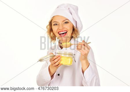 Smiling Female Chef With Glass Jar Of Dry Corn Grits. Organic Food. Polenta. Professional Chef Cooki