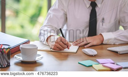 Executive Manager Jot Meeting Record Of Business Finance Onto Paper Report Beside Computer Mouse, Ke