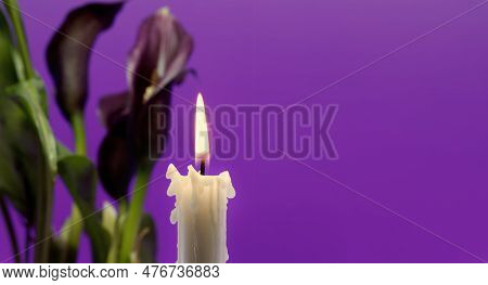 Banner Size Image Of Burning Candle And Purple Sepals Of The Calla Lily Against A Purple Background 