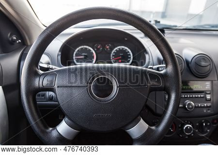 Interior View With Steeering Wheel And Dashboard Of Luxury Very Expensive New White Car Stands In Th