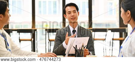 Confidence Male Broker Talking, Consulting, Giving Instructions, Explaining Terms Of Contract To Bus