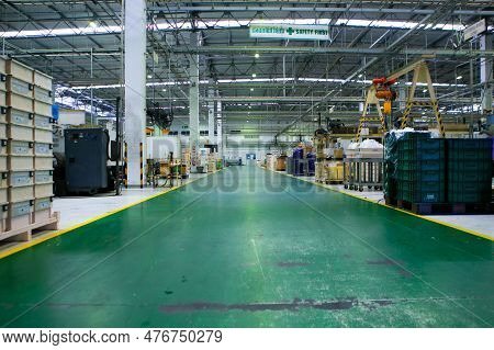 The Factory Walkway And Machine For Processing Metal Part Of Car. Warehouse And Store Keep Material 