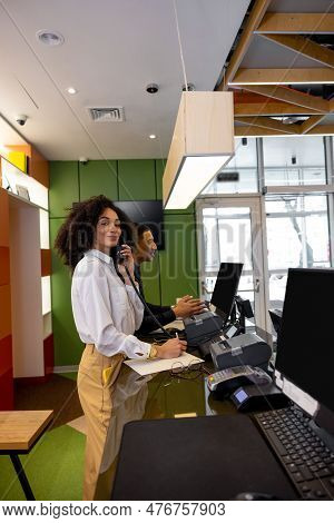 Team Of Receptionists Working At The Hotel Reception Desk