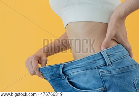 Women Showing Results Of Diet. Beautiful Shape. Female Have A Reduced Waist Size After Under Going A