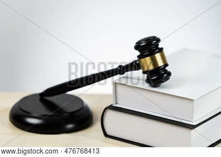 Closeup Wooden Gavel Hammer And Law Book In Empty Law Firm Or White Lawyer Office Background As Just
