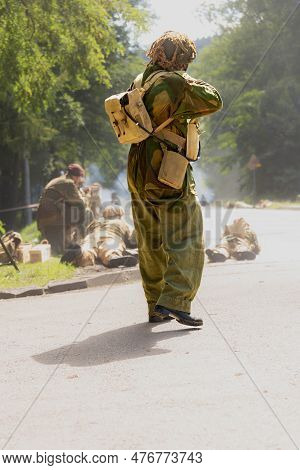Reconstruction Of Battle From The Second World War. British Paratrooper Soldier During Combat. View 