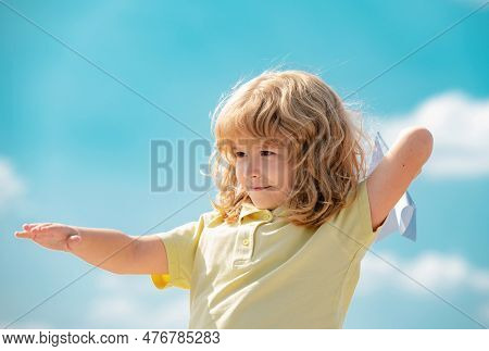 Kid Dreaming And Plays With A Toy Plane In The Park. Dreams Of Travel. Development, Growth, Dreams A