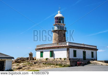 Corrubedo Lighthouse In The Atlantic Ocean, Galicia, Spain. Lighthouse On Top Of A Rock Crag For Saf