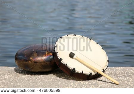 Different Drums And Drumstick Near Sea. Percussion Musical Instruments