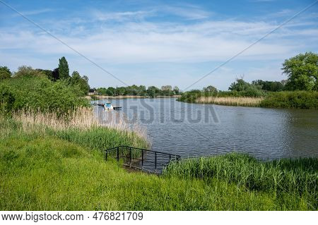 Green Banks Of The River Durme With A Ferry At The Pier, Temse, Flanders, Belgium