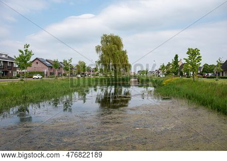 Hulst, Zeeland, The Netherlands - May 21, 2023 - Green Park Around The Inner Canal Of The Historical