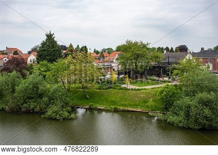 Hulst, Zeeland, The Netherlands - May 21, 2023 - Green Park Around The Canal Of The Historical City 