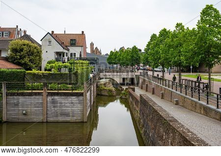Hulst, Zeeland, The Netherlands - May 21, 2023 - Historical Buildings Reflecting In The Water Of The