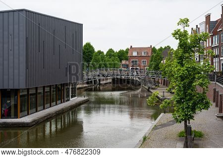 Hulst, Zeeland, The Netherlands - May 21, 2023 - Historical Buildings Reflecting In The Water Of The