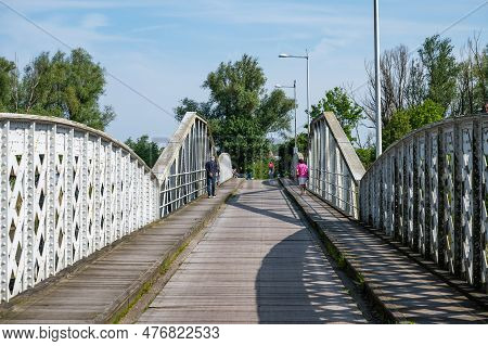 Hamme, East Flemish Region, Belgium - May 18, 2023 - Wooden Pdestrian Bridge Over The Old Durme Rive