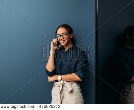 Young Female Entrepreneur In Thought Sitting On The Floor In The Kitchen With A Laptop On Her Legs