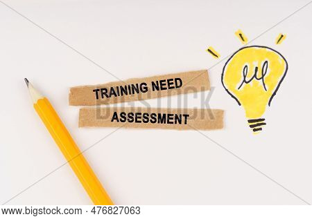 Business And Education Concept. A Luminous Light Bulb Is Drawn On A White Background, Next To It Lie
