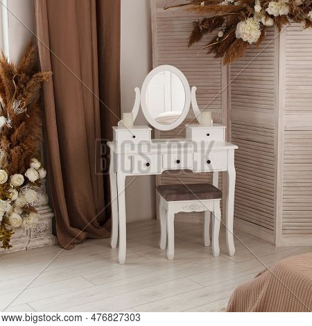 White Dressing Table With Oval Mirror And Chair Is Part Of Cosy Interior Of Beautiful Contemporary B