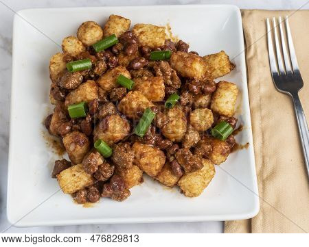 Tater Tots  Mixed With Chili  And Top  Wioth Green Onions