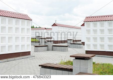 Rows Of White Walls For The Burial Of Ashes After Cremation. Empty Cells For Urns With Ashes. Benche