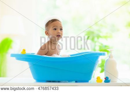 Baby Boy In Bath. Mother Washing Infant Child.