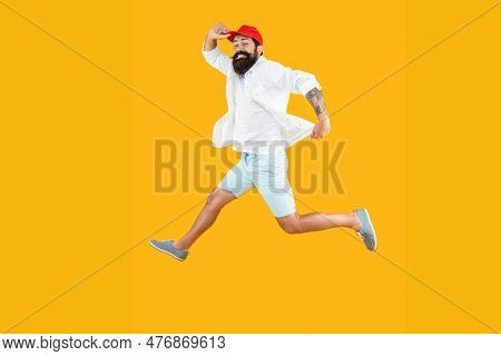 Hurrying Man Deliveryman On Background. Full Length Photo Of Hurrying Man Deliveryman Jumping
