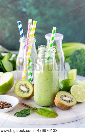 A Healthy Green Smoothie In Glass Bottles, Ready For Drinking.