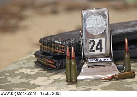 Coat Of Arms Of Ukraine From Bullets On Camouflage Clothing And Retro Calendar With Date Of Beginnin