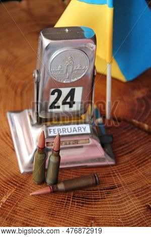 Coat Of Arms Of Ukraine From Bullets On Camouflage Clothing And Retro Calendar With Date Of Beginnin