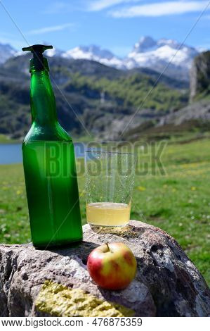 Green Bottle And Glass Of Natural Asturian Cider Made From fermented Apples With View On Covadonga L