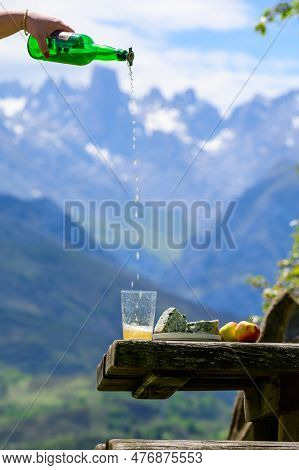 Pouring From High Height Of Natural Asturian Cider Made From fermented Apples, Asturian Cabrales Cow