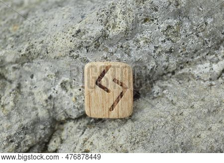 Wooden Rune Jera On Stone Outdoors, Closeup