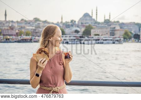 Woman In Istanbul Having Breakfast With Simit And A Glass Of Turkish Tea. Glass Of Turkish Tea And B